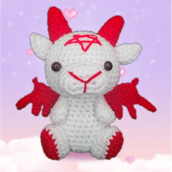 cabra de peluche marca Despojo & Esponjoso Baby Baphy blanca con detalles rojos